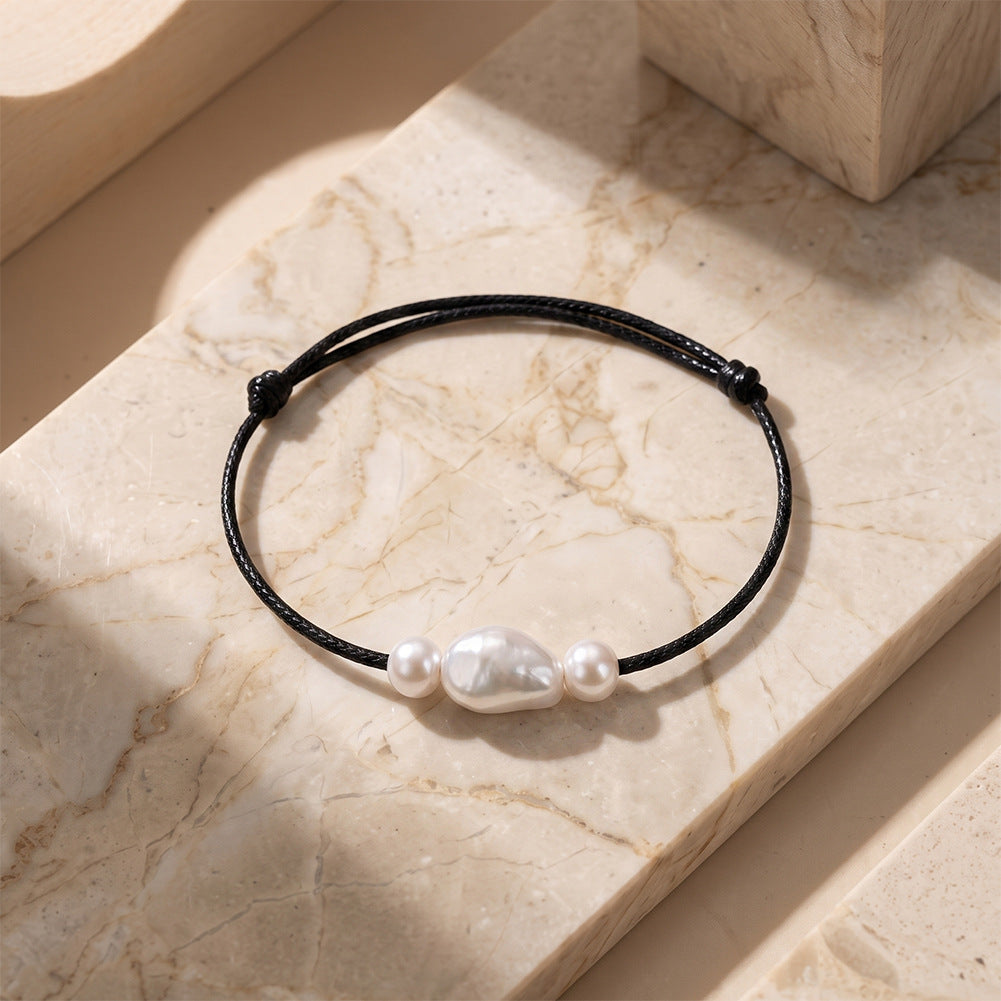 Adjustable Black Wax Cord Bracelet, Lustrous Baroque Freshwater Pearl Center Flanked by Two Small Round Pearls, Sliding Knot Design